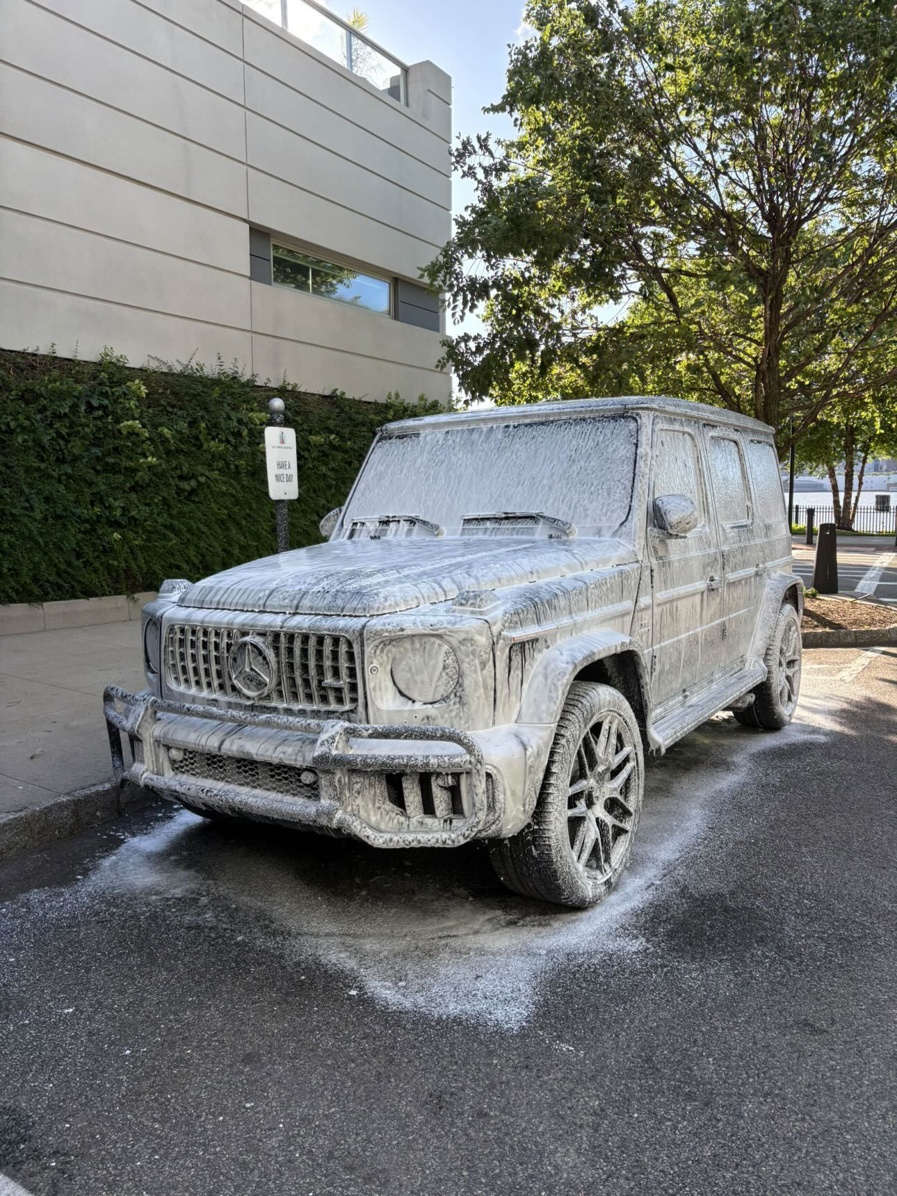 Mercedes-AMG G63 SUV blanketed in thick snow foam during pre-wash